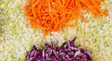 close up of diced coleslaw with carrots and red cabbage separated