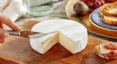 brie cheese wheel, sliced