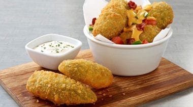 jalapeno poppers appetizer with ramekin of sauce on board