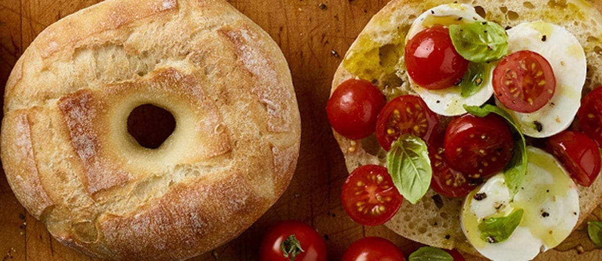 baguette bagel with tomatoes, fresh mozzarella and basil