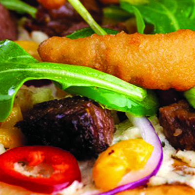 flatbread with bbq brisket, onion, peppers, arugula, goat cheese on wood platter