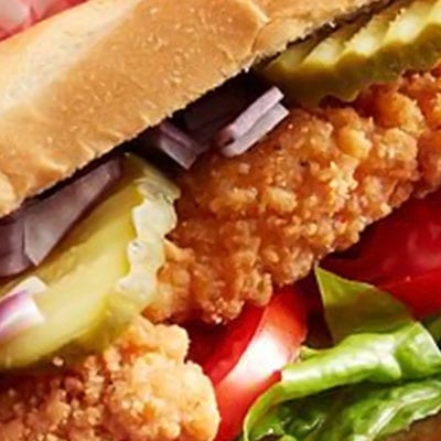 chicken sandwich with tomato, onions and pickles