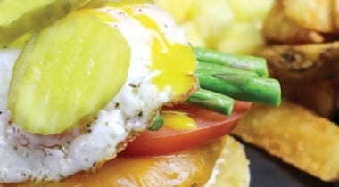 chicken burger with pickles, eggs and fries