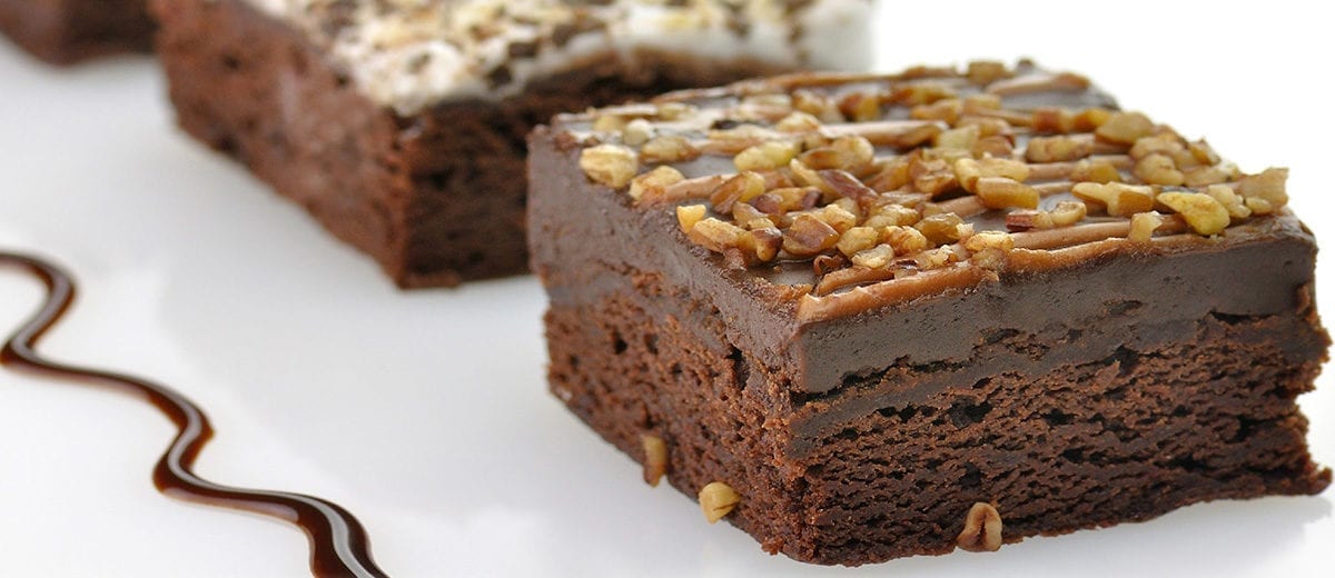 brownies with chocolate fudge topping and crushed walnut topping