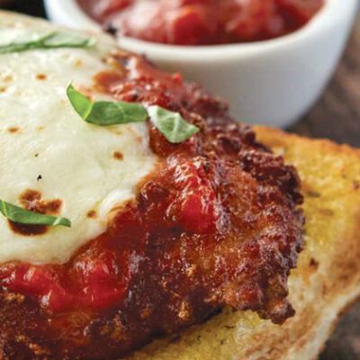 cooked chicken parmesan on toasted bread