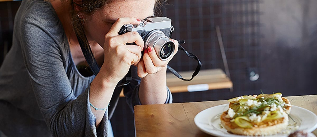 woman taking photo of food