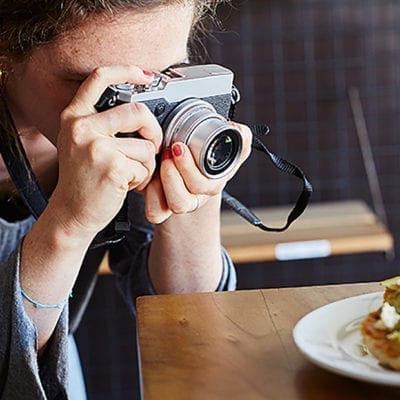 woman taking photo of food