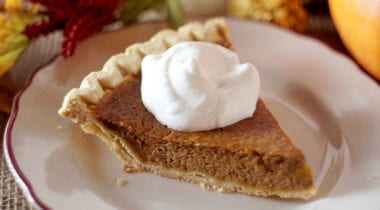 slice of pumpkin pie with whipped cream