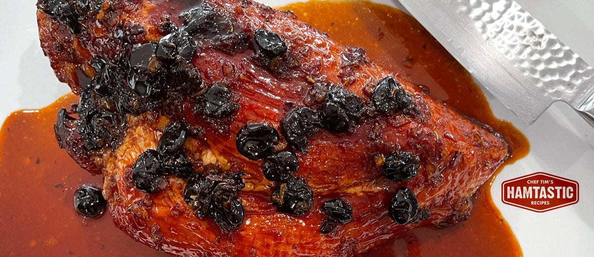 ham with red glaze sauce and dried cherries