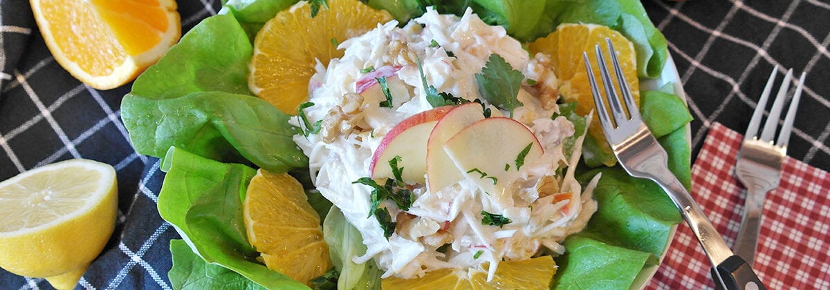 crab salad on lettuce with apple slices and lemons