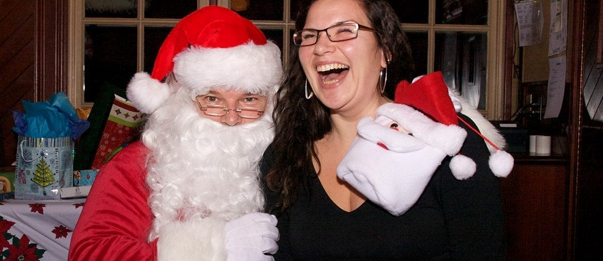 woman laughing on santa's lap