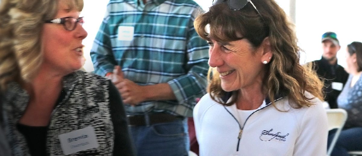 smiling woman with white shirt in crowd