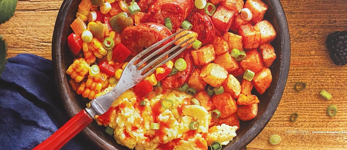 scrambled eggs with sausage and hot sauce in a bowl