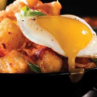 tater tots topped with bacon and eggs