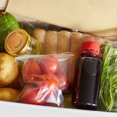 hands holding box of food ingredients