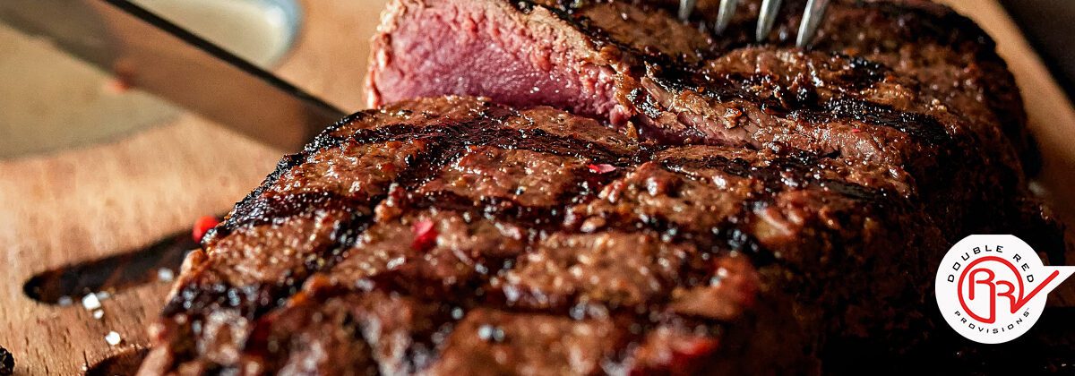 Choice angus beef steak being cut into with ranch seasoning