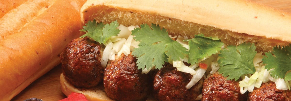 meatball sub with parsley and shredded mozzarella