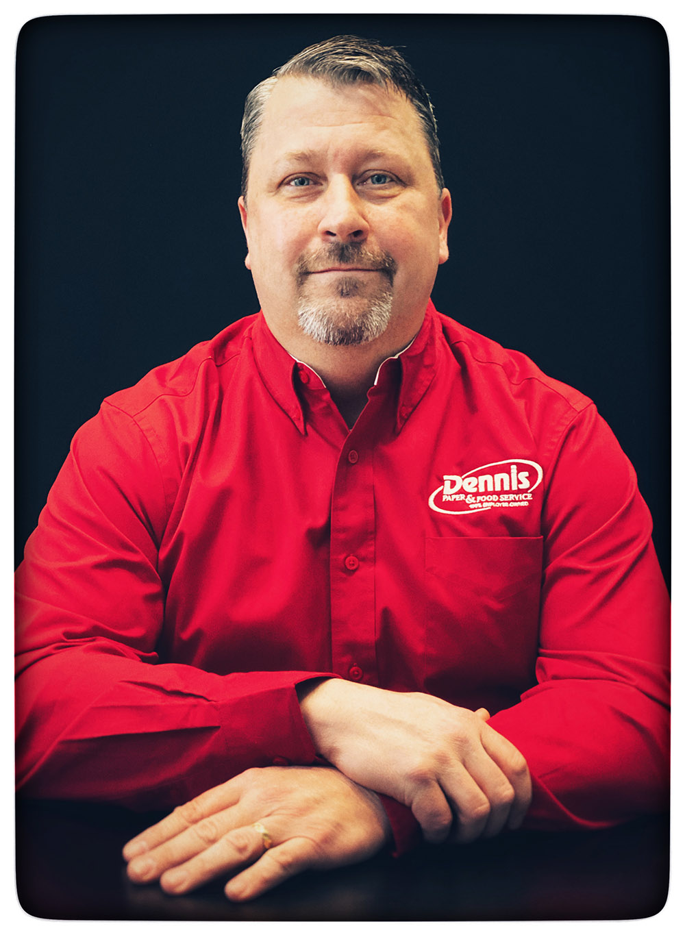 man in red shirt arms crossed