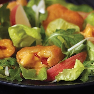 garden salad with pizza bites on it