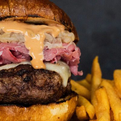 burger topped with Reuben ingredients