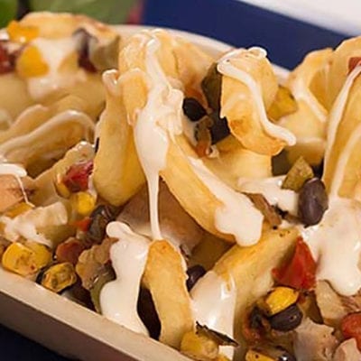 roasted nachos with strawberries and breadstick on school tray