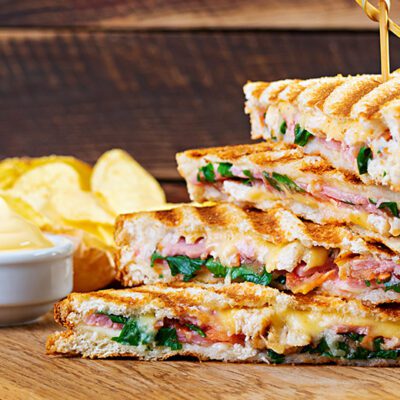 stack of grilled sandwiches on cutting board