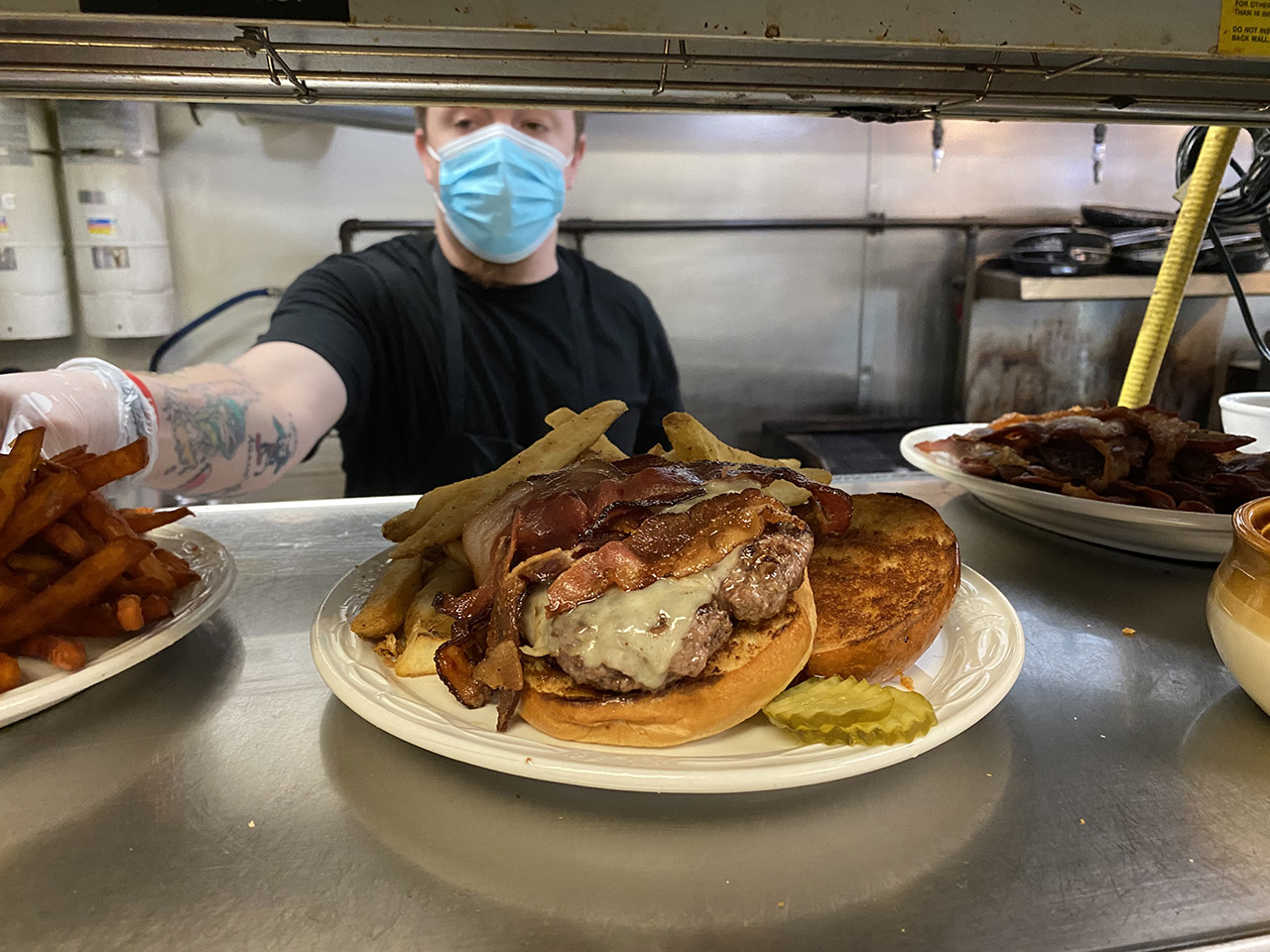 cheeseburger and fries in restaurant kitchen