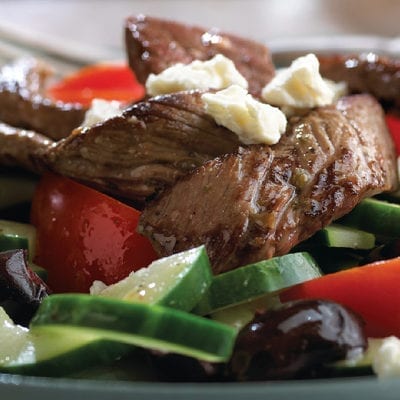 salad with steak, tomatoes and cheese crumbles