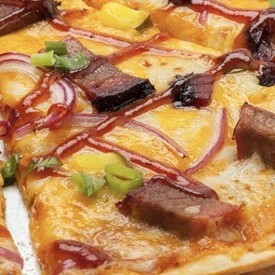 thin crust pizza with meat and jalapenos