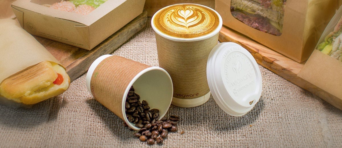 kraft paper coffee cups with coffee beans and latte foam