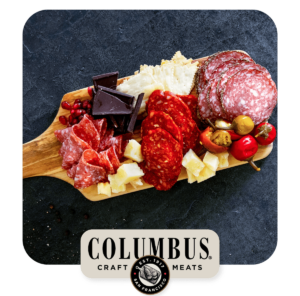 Charcuterie board on wooden tray on a dark background